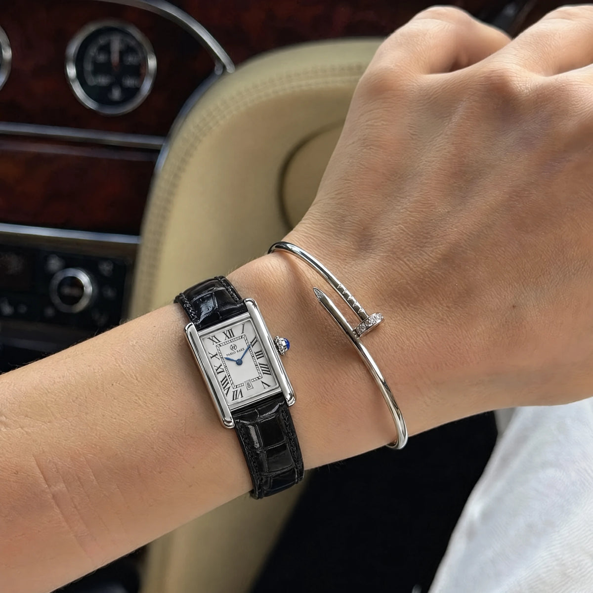 Houston Essence 28mm worn on a woman's wrist with black leather strap and a silver bangle #color_black