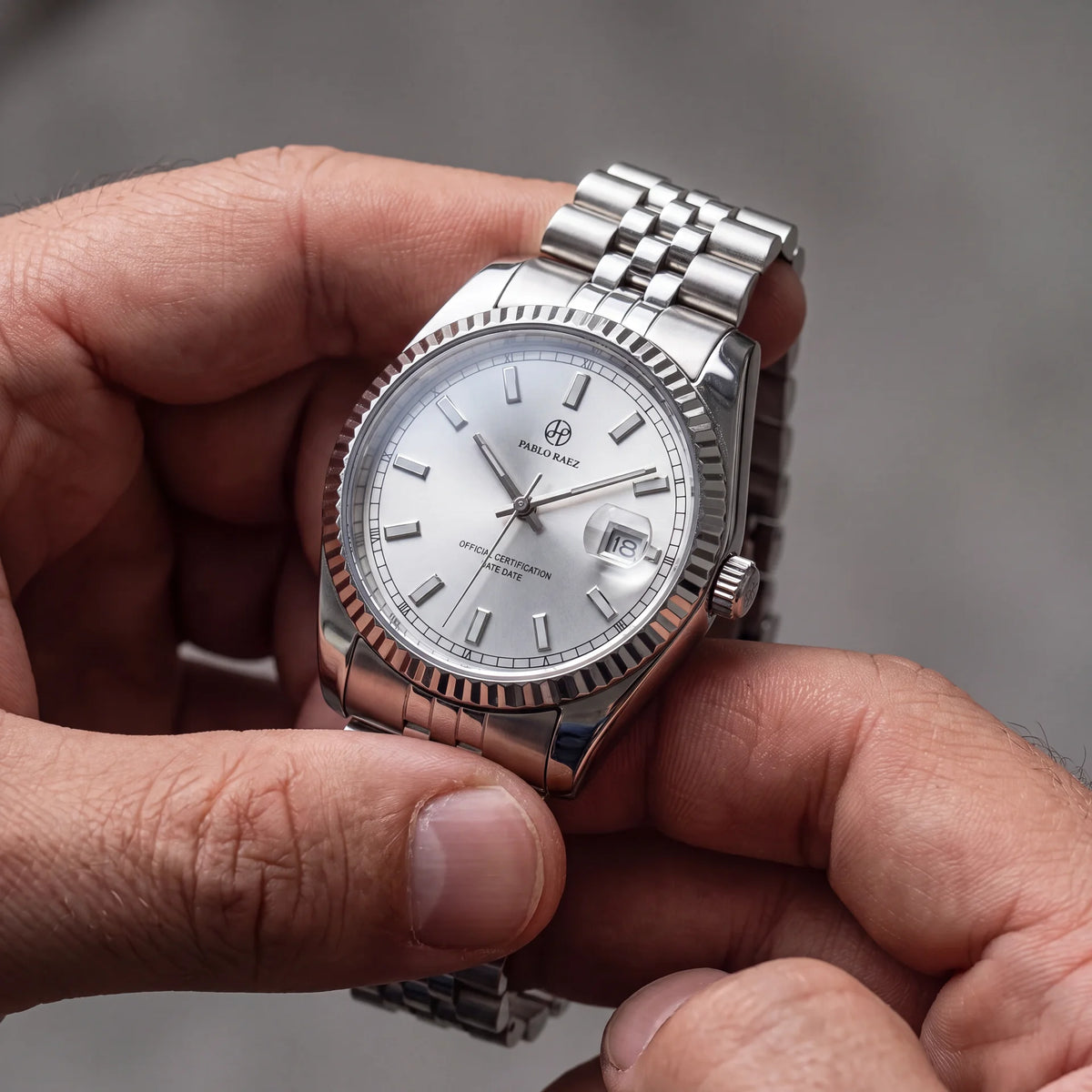 Diplomat Silver 40mm white dial watch held in hand #color_white