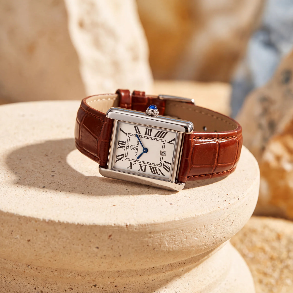 Houston Essence 28mm with brown leather strap resting on a stone pedestal #color_brown