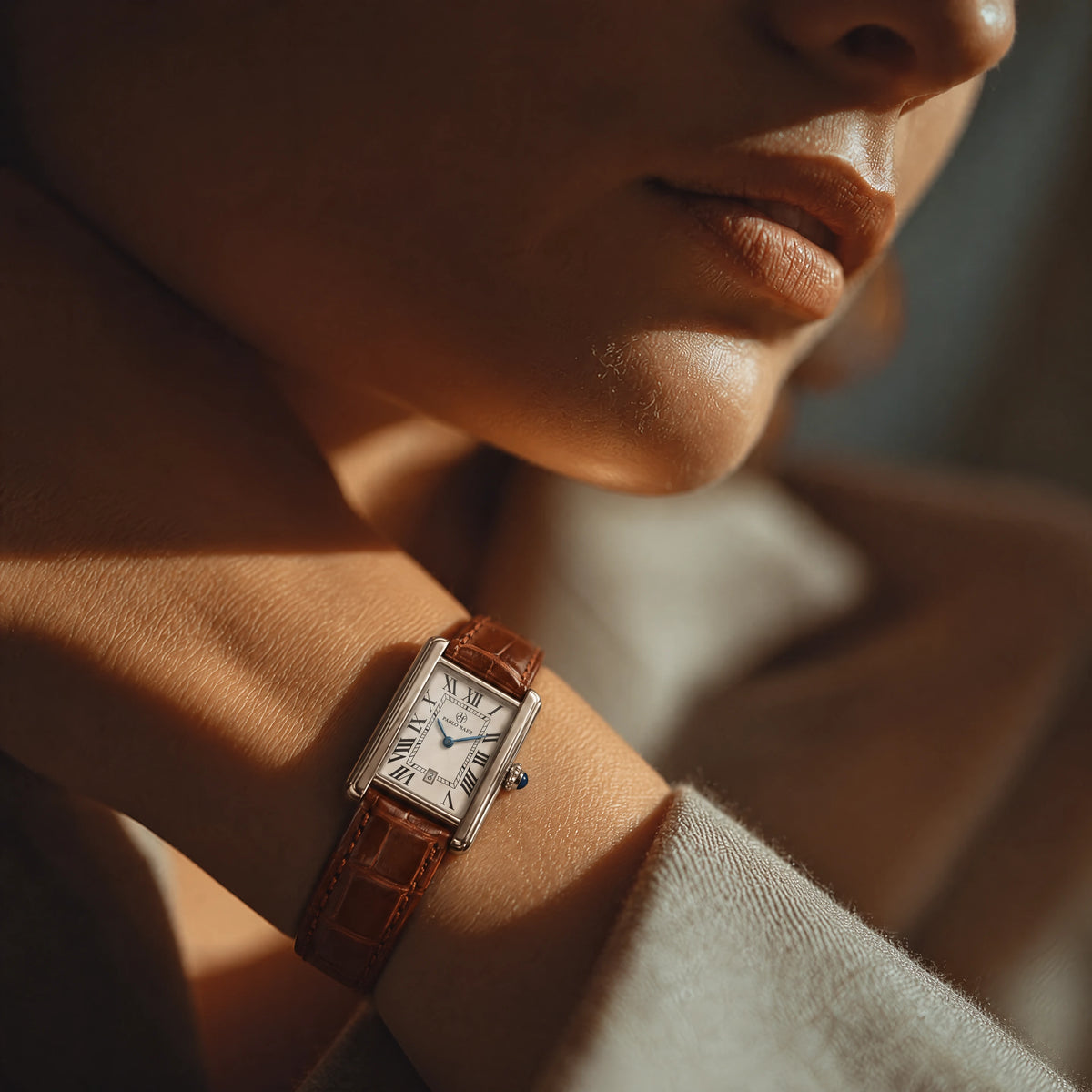 Houston Essence 28mm worn on a woman's wrist, brown leather strap seen against a cream coat #color_brown