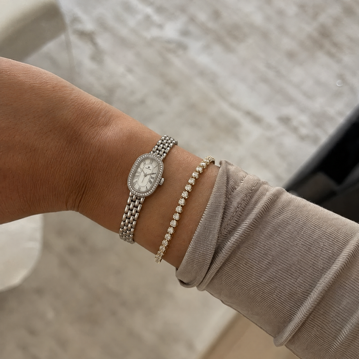 Belgrave 21mm silver women's watch worn on the wrist beside a diamond tennis bracelet #color_silver