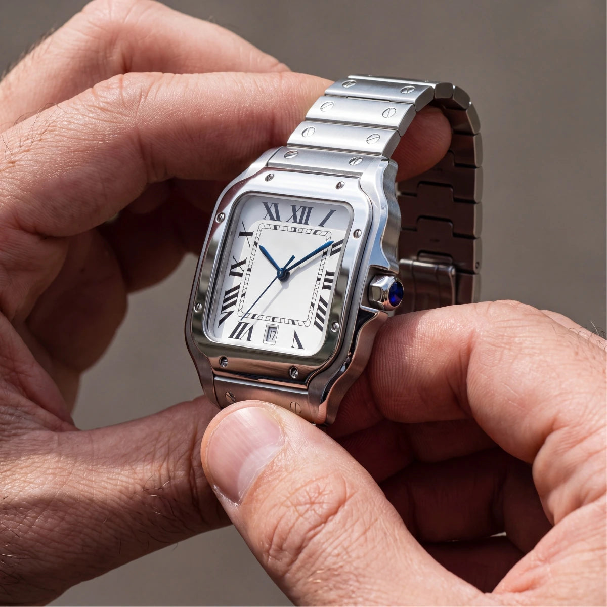 Sloane Silver 40mm square steel watch held in hand
