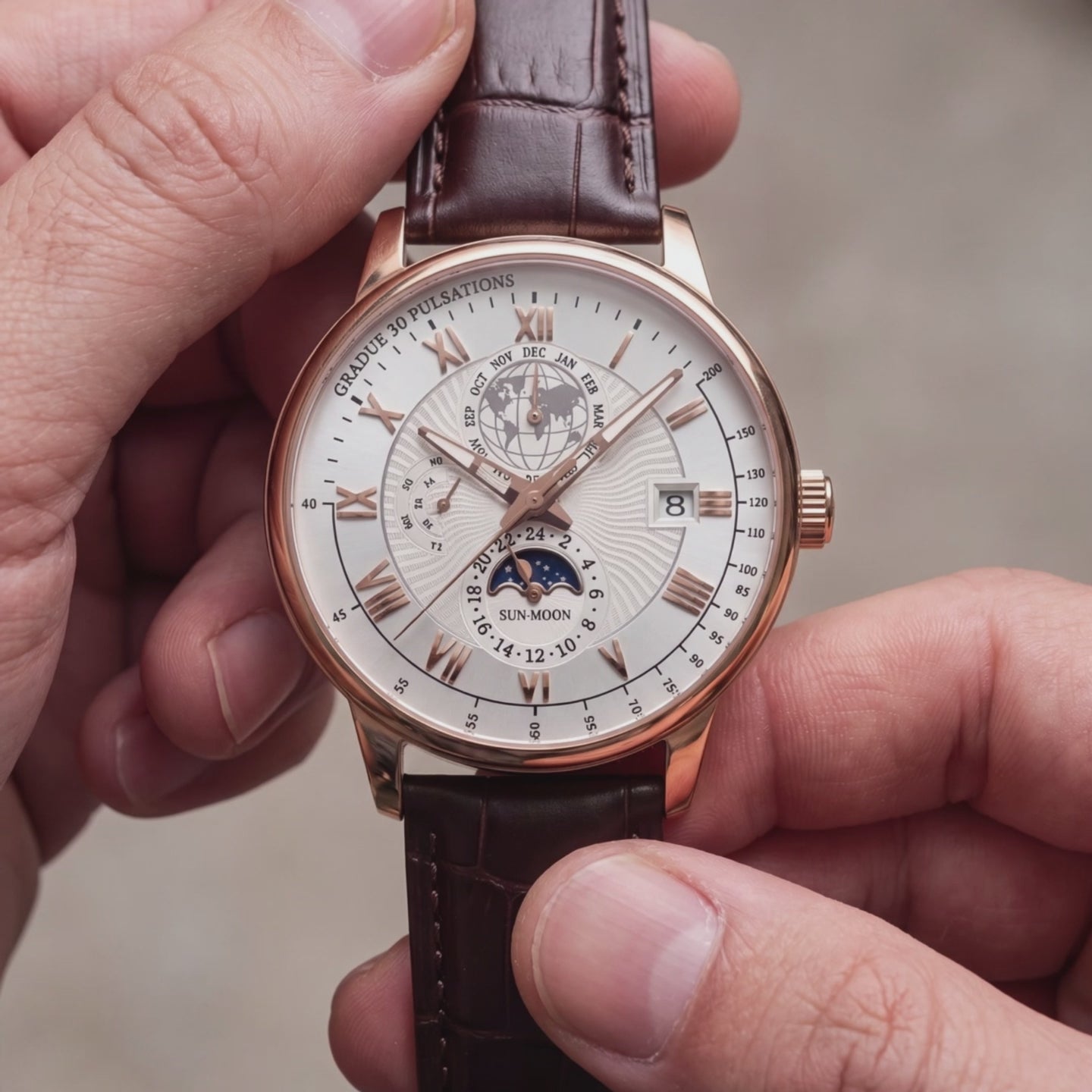 Moon 42mm rose gold moonphase watch held in hand