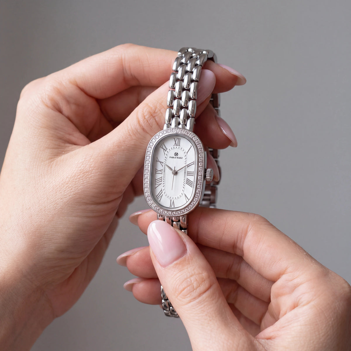 Belgrave 21mm silver women's watch held in hand #color_silver